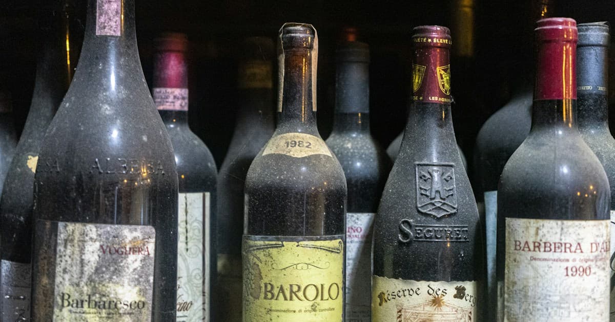 several bottles of wine are lined up on a shelf